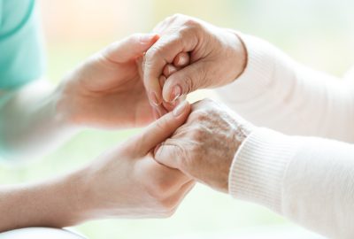 jongere en oudere handen die elkaar vasthouden - Hospice-info